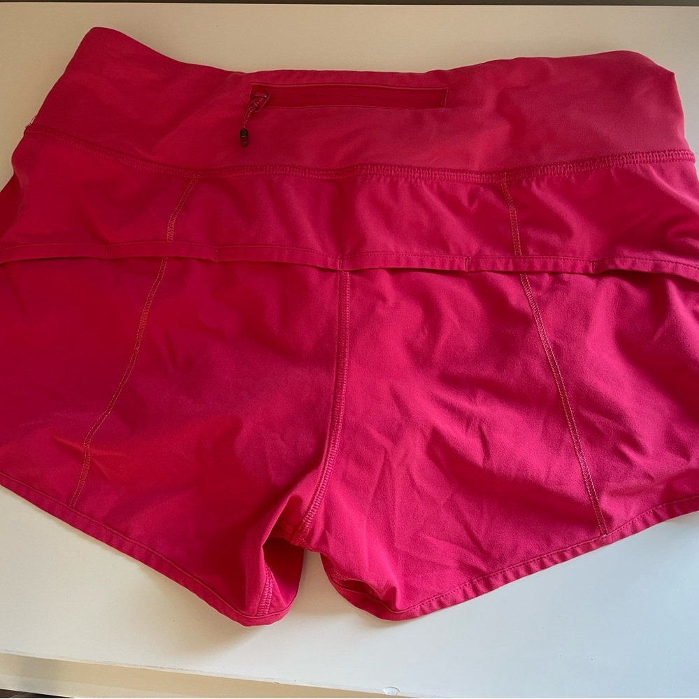 Pinkish red lululemon speed up shorts. They are a size 4.